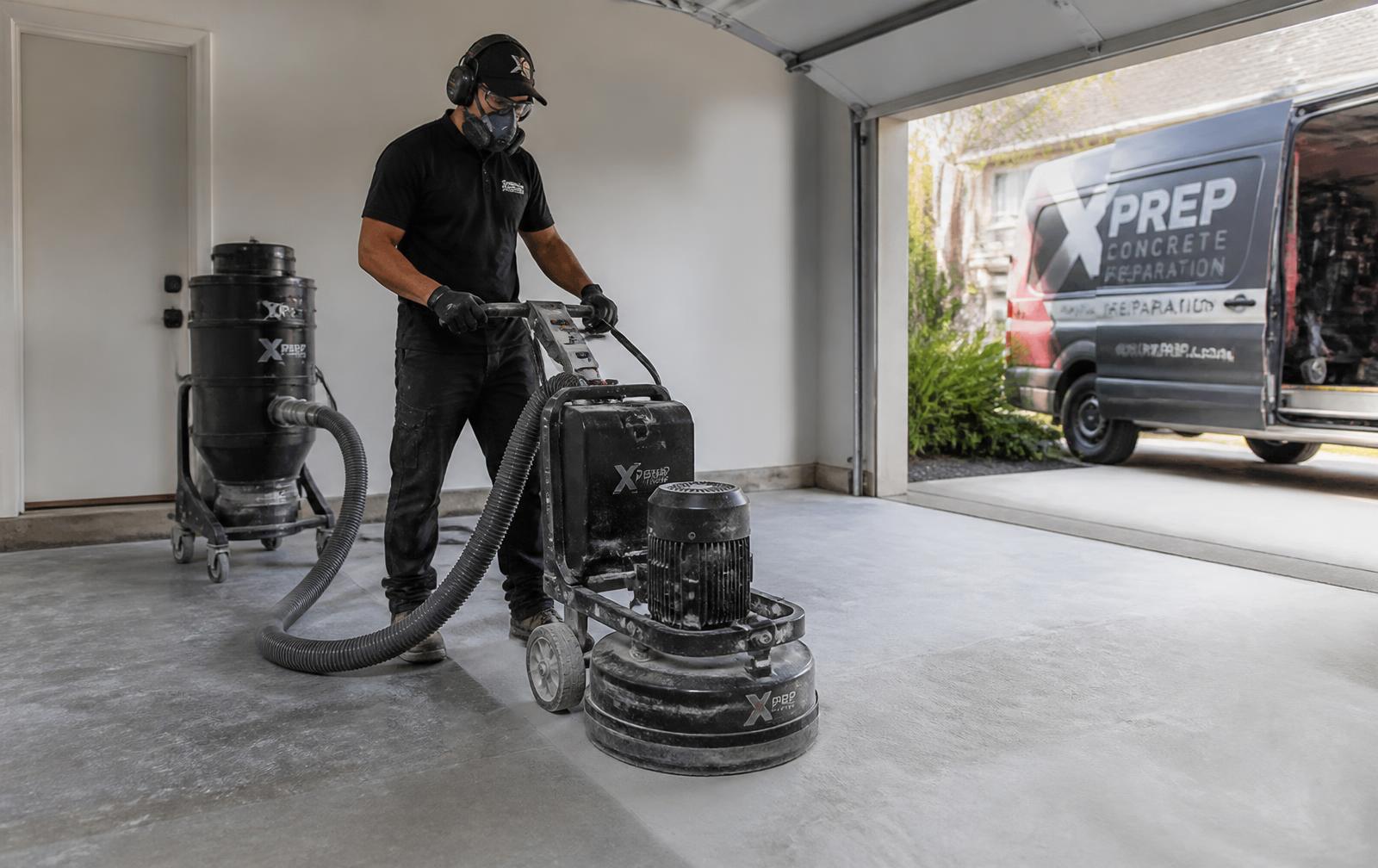 Diamond grinding a residential garage concrete slab before coating